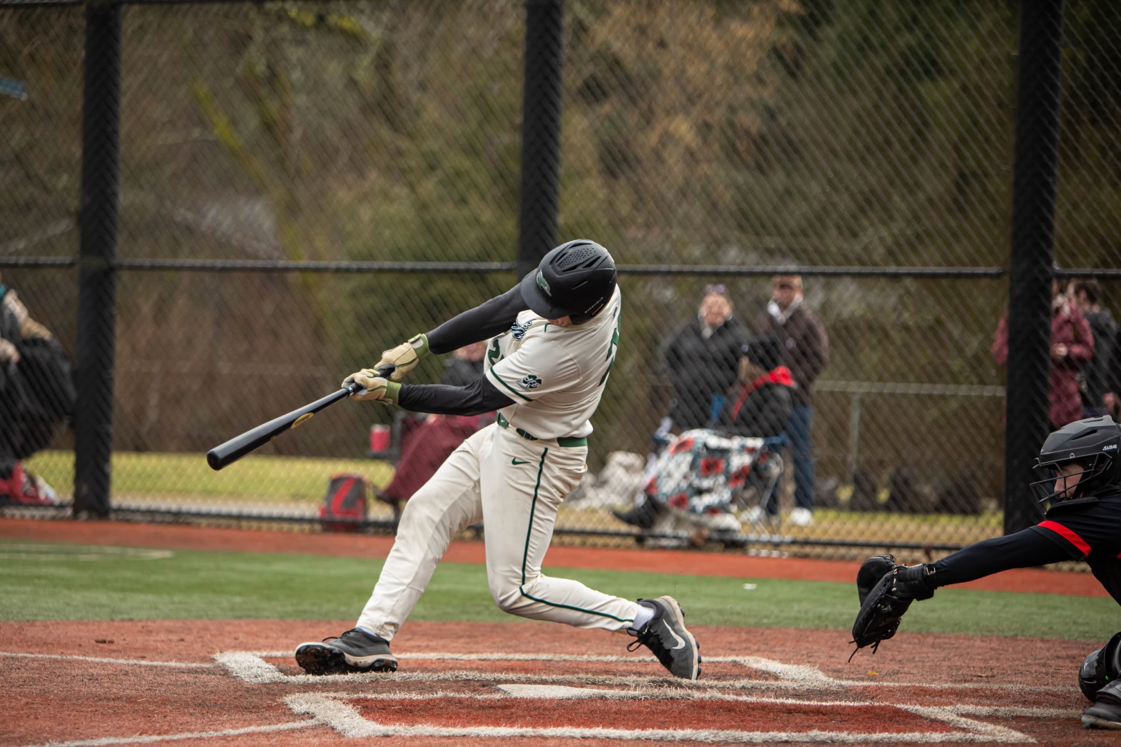 Shoreline batter driving the ball during a home game