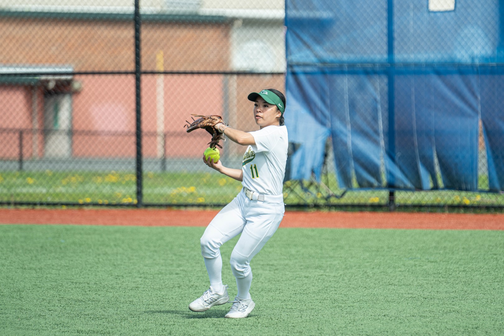 Shoreline softball infielder making a throw across the field