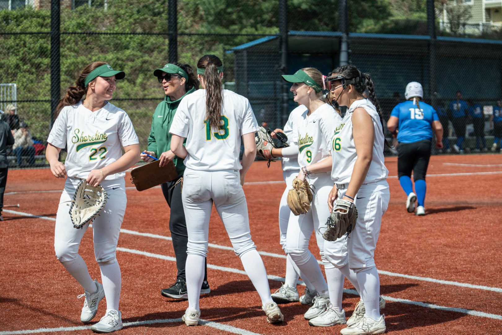 Shoreline softball team huddling with their coach on the field